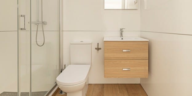 A stylish small bathroom with a frameless walk-in shower, clean lines, and light finishes that create a spacious, spa-like feel