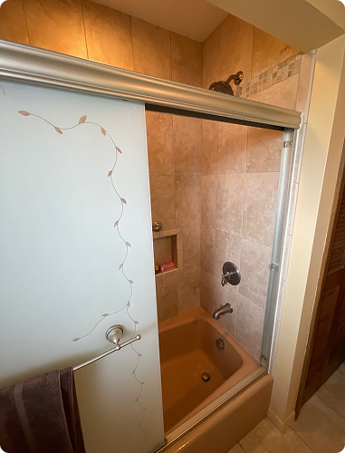 Small, cramped bathroom with a high tub wall